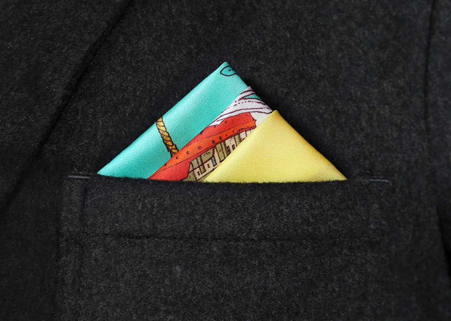 Brightly coloured silk pocket square in a grey blazer