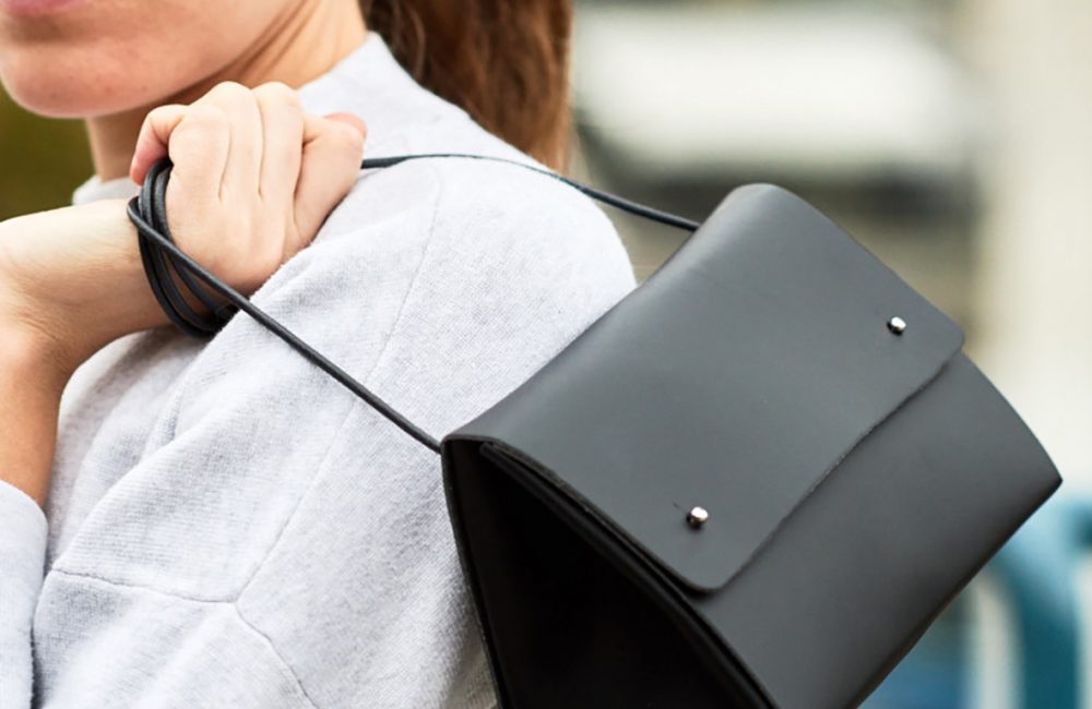Woman carrying a black handbag