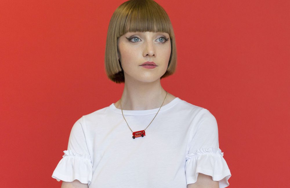 Woman wearing a red London bus necklace