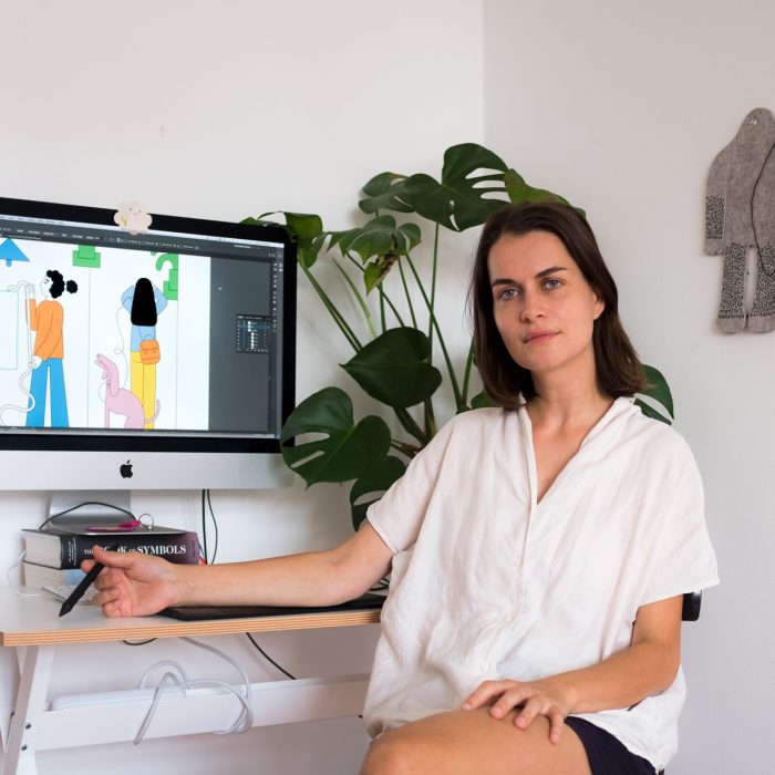 Photograph of illustrator Martina Paukova at her computer